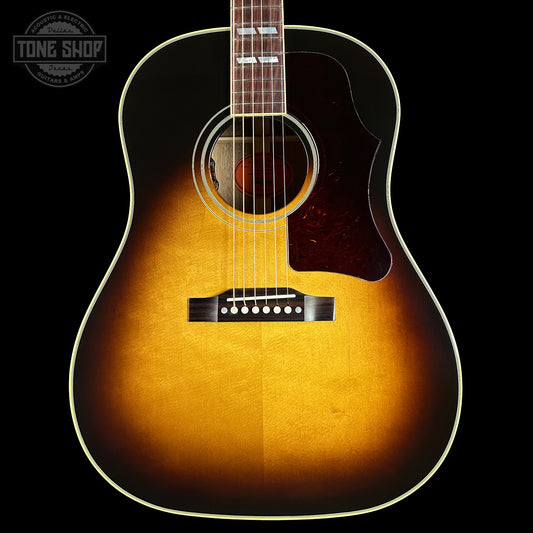 Acoustic guitar with a sunburst finish on a black background, featuring the Tone Shop logo.