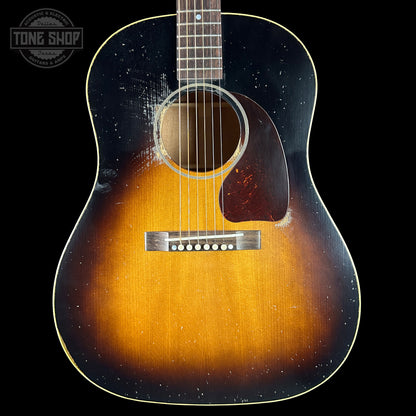 Acoustic guitar with a sunburst finish on a black background, featuring the Tone Shop logo.
