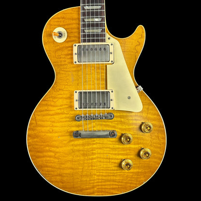 Electric guitar with a sunburst finish on a black background, featuring the Tone Shop logo.