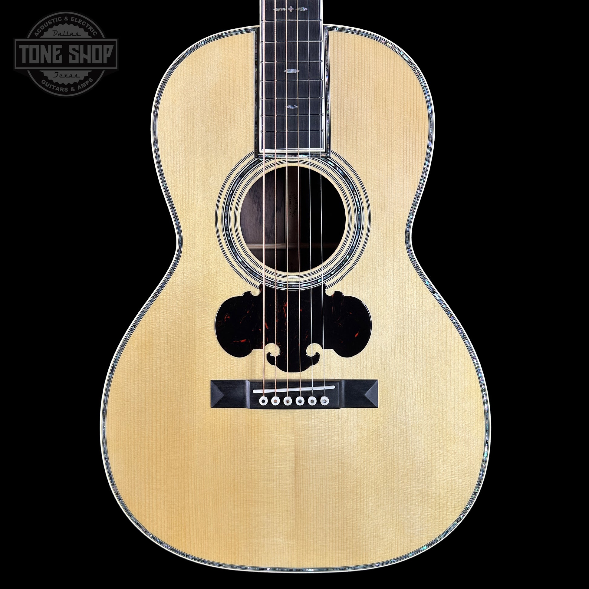 Acoustic guitar with a visible brand logo in the corner