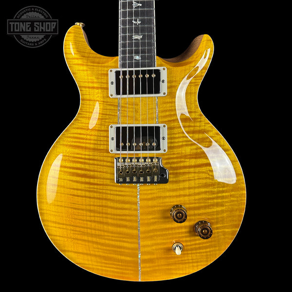 Yellow electric guitar with a black background