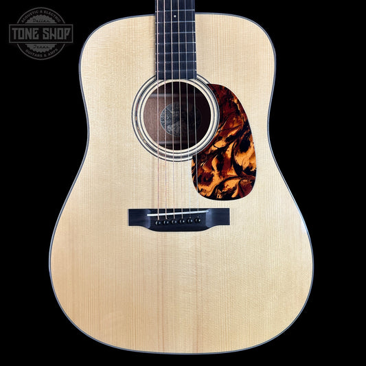 Acoustic guitar with tortoiseshell pickguard on a black background, featuring 'Tone Shop' logo.