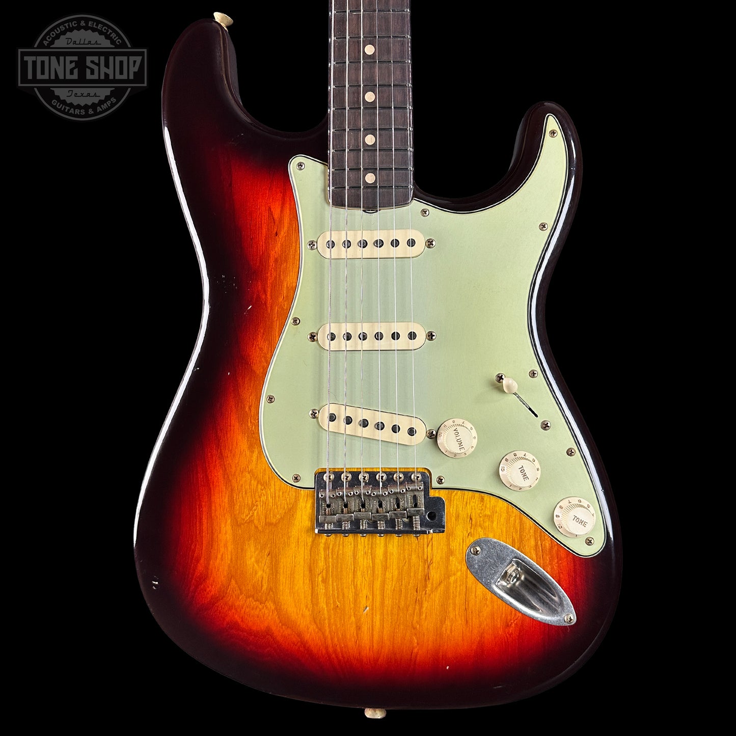 Electric guitar with a sunburst finish on a black background, featuring the Tone Shop logo.