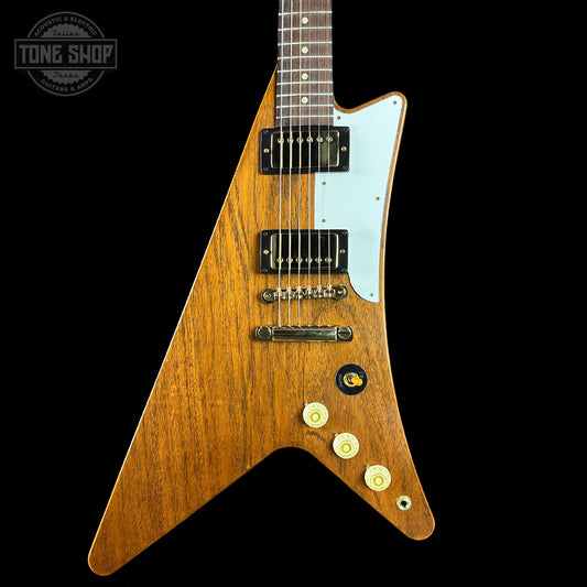 Wooden electric guitar with a white pickguard on a black background, featuring the Tone Shop logo.