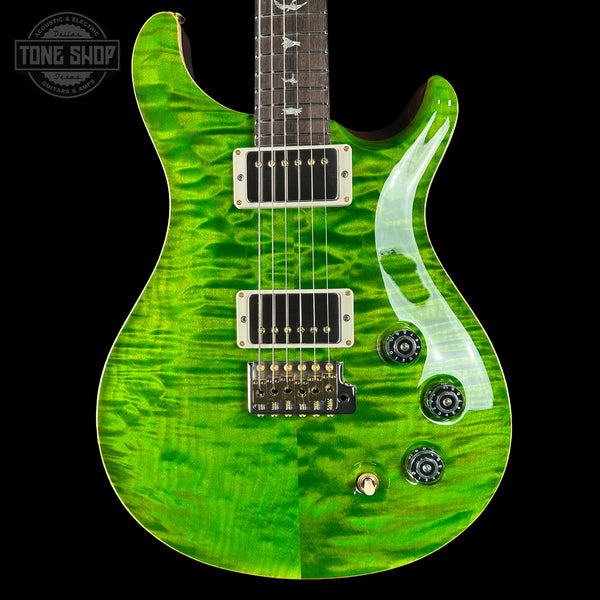 Green electric guitar with a black pickguard on a black background, featuring the Tone Shop logo.