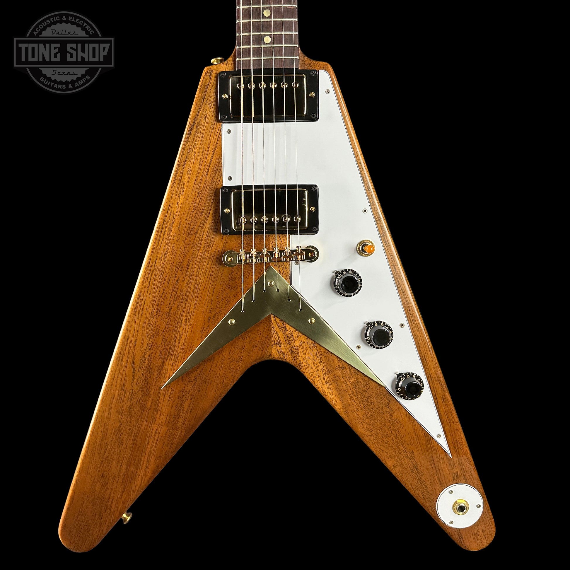 Wooden electric guitar with a white pickguard on a black background, featuring the Tone Shop logo.