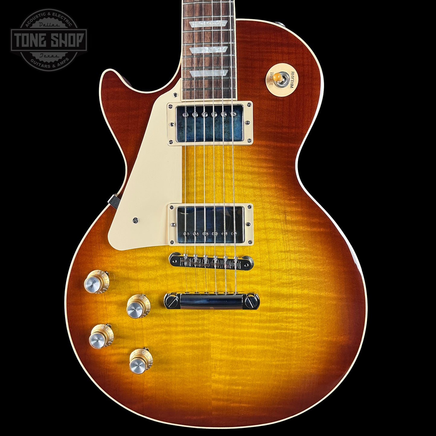 Electric guitar with a sunburst finish on a black background, featuring the Tone Shop logo.