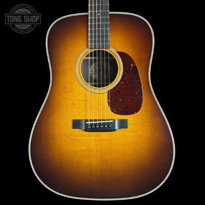 Acoustic guitar with a sunburst finish on a black background, featuring the Tone Shop logo.