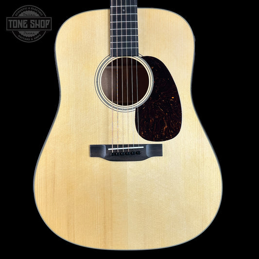 Acoustic guitar with a visible brand logo on a black background