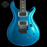 Blue electric guitar on a black background with 'Tone Shop' logo.