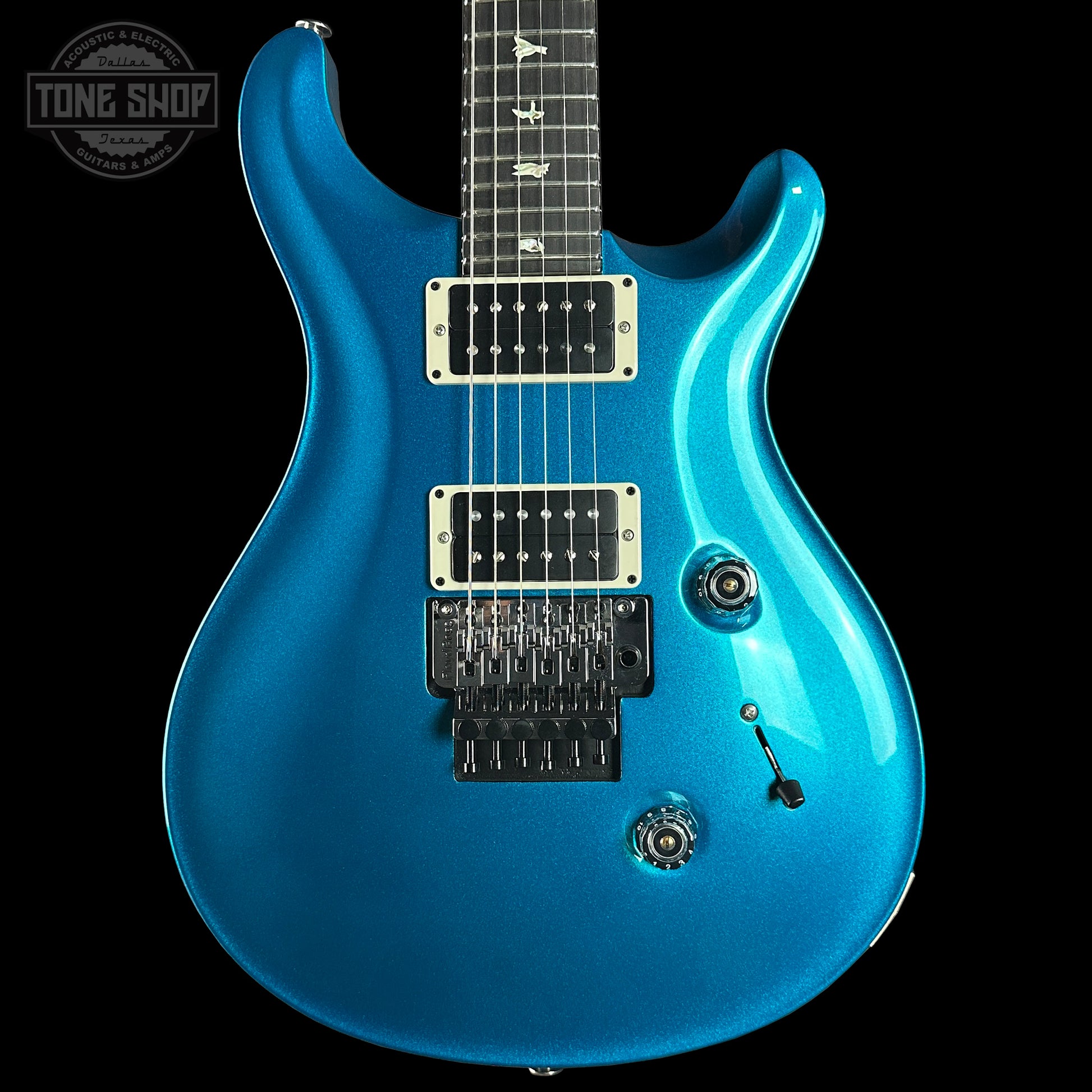 Blue electric guitar on a black background with 'Tone Shop' logo.