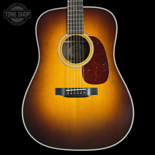 Acoustic guitar with a sunburst finish on a black background, featuring the Tone Shop logo.
