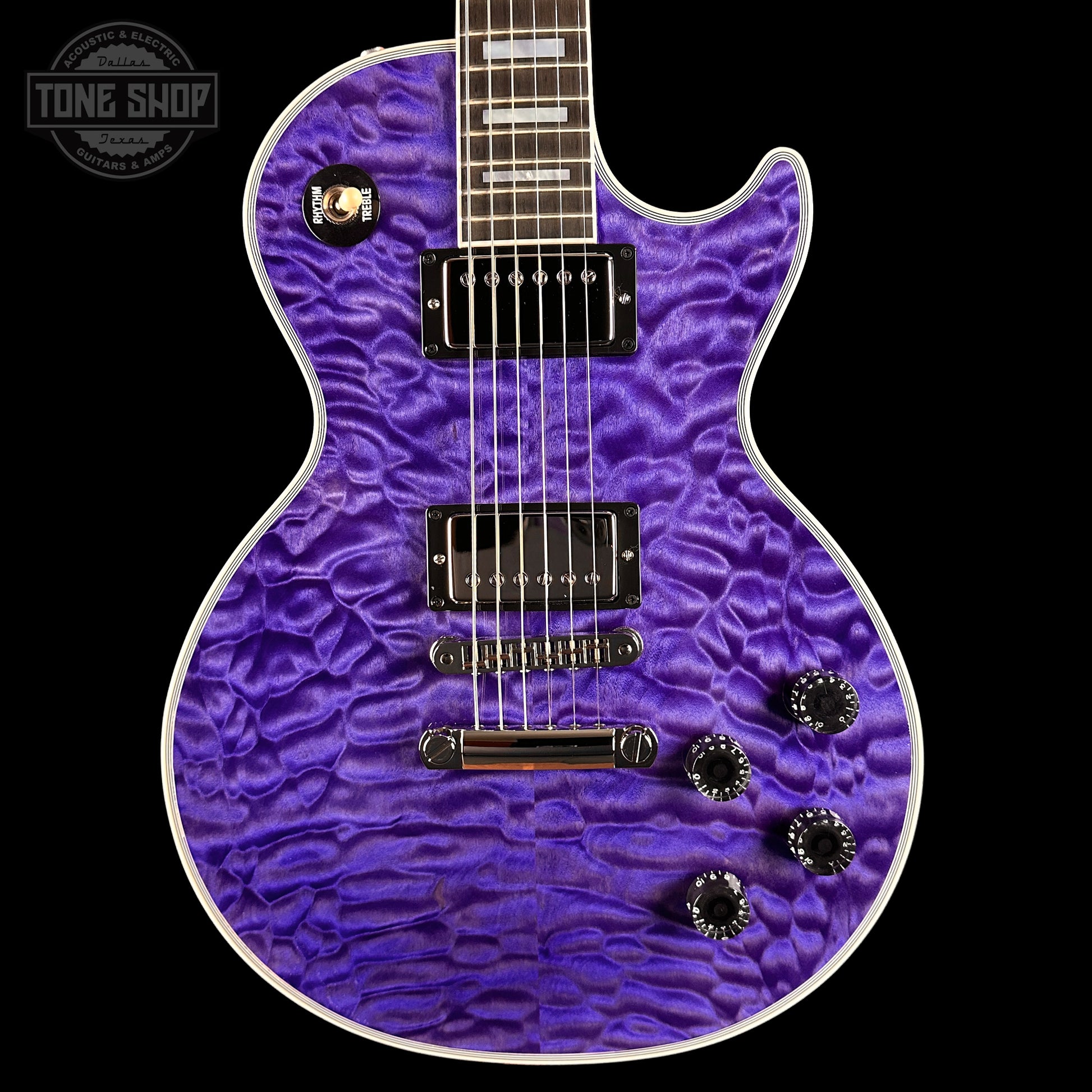 Purple electric guitar with a textured finish on a black background, featuring the Tone Shop logo.