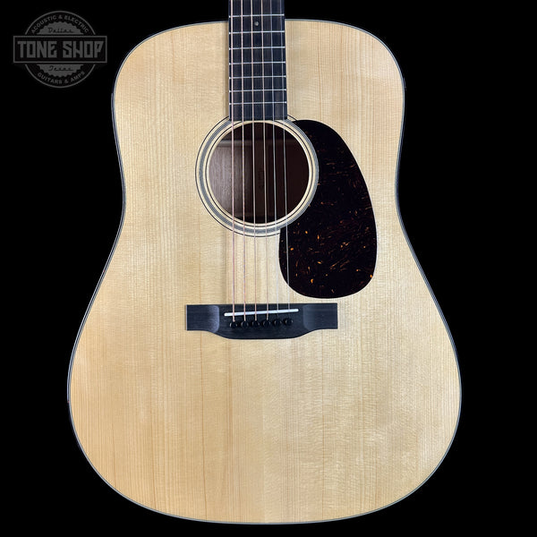 Acoustic guitar with a visible brand logo in the corner
