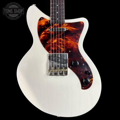 White electric guitar with tortoiseshell pickguard on a black background, featuring 'Tone Shop' logo.