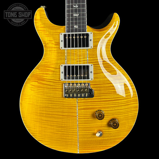 Yellow electric guitar with flame pattern on a black background, featuring 'Tone Shop' logo.