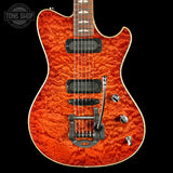 Electric guitar with a quilted orange finish on a black background, featuring the Tone Shop logo.