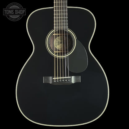 Black acoustic guitar on a black background with 'Tone Shop' logo.