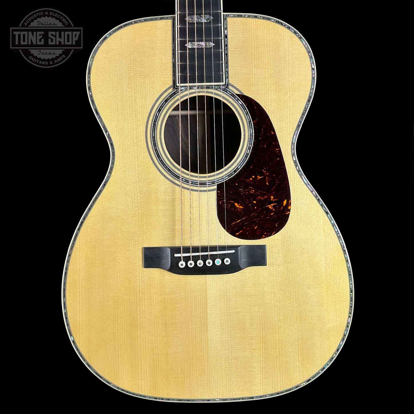 Acoustic guitar with a visible brand logo in the corner