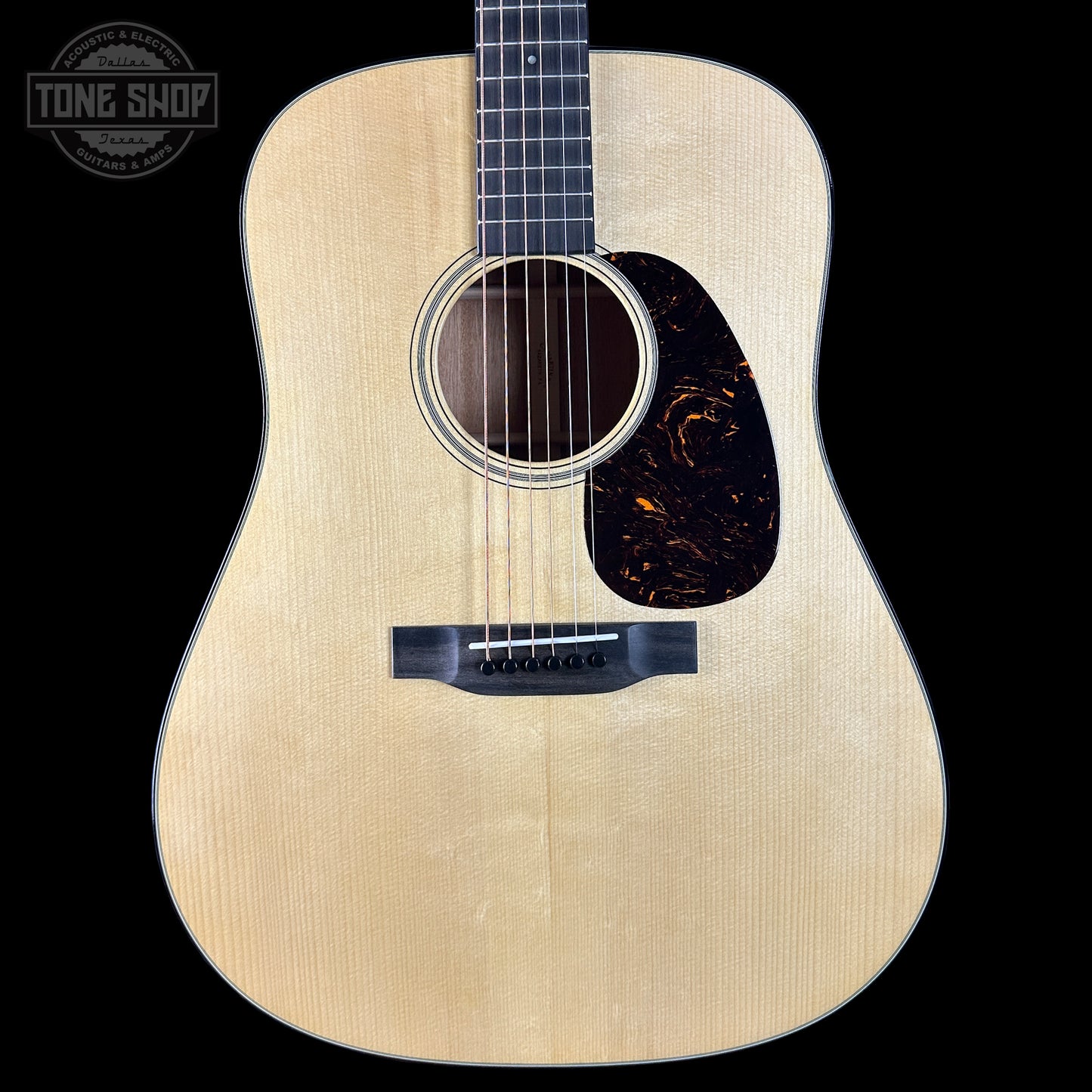 Acoustic guitar with a visible brand logo in the corner