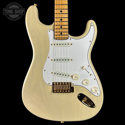 Electric guitar with a blonde finish on a black background, featuring the Tone Shop logo.