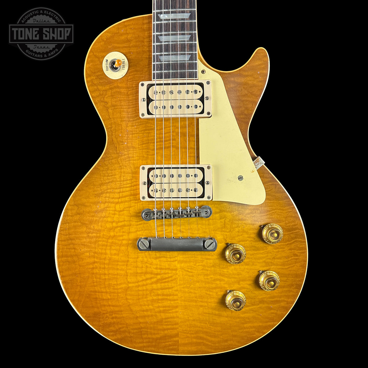 Electric guitar with a sunburst finish on a black background, featuring the Tone Shop logo.