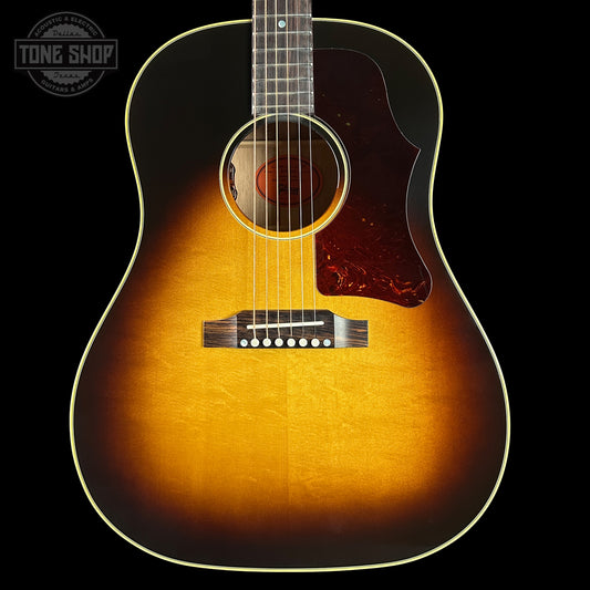 Acoustic guitar with a sunburst finish on a black background, featuring the Tone Shop logo.