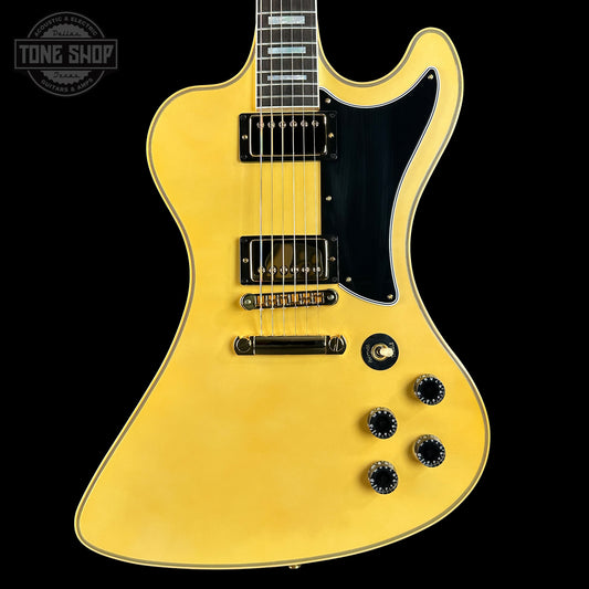 Yellow electric guitar with a black pickguard on a black background, featuring the Tone Shop logo.