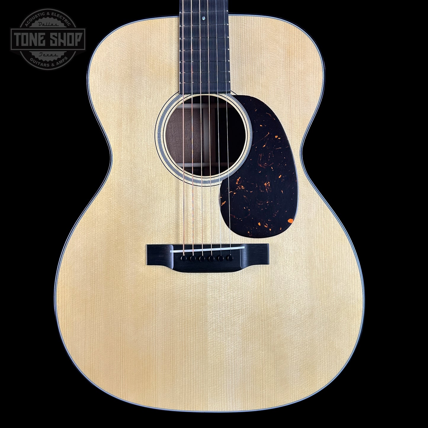 Acoustic guitar with a visible brand logo in the corner