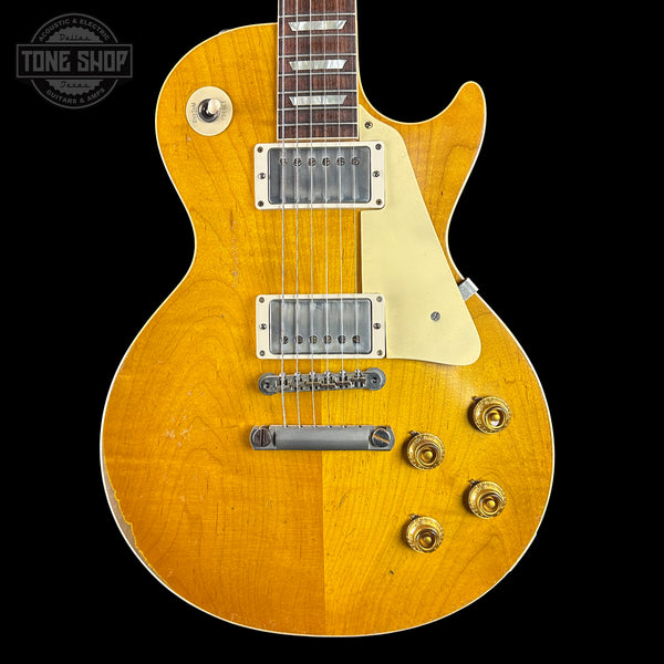 Electric guitar with a sunburst finish on a black background, featuring the Tone Shop logo.