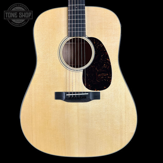 Acoustic guitar with a visible brand logo on a black background