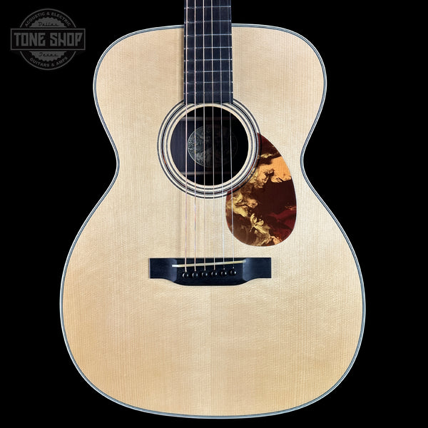 Acoustic guitar with a visible brand logo in the corner