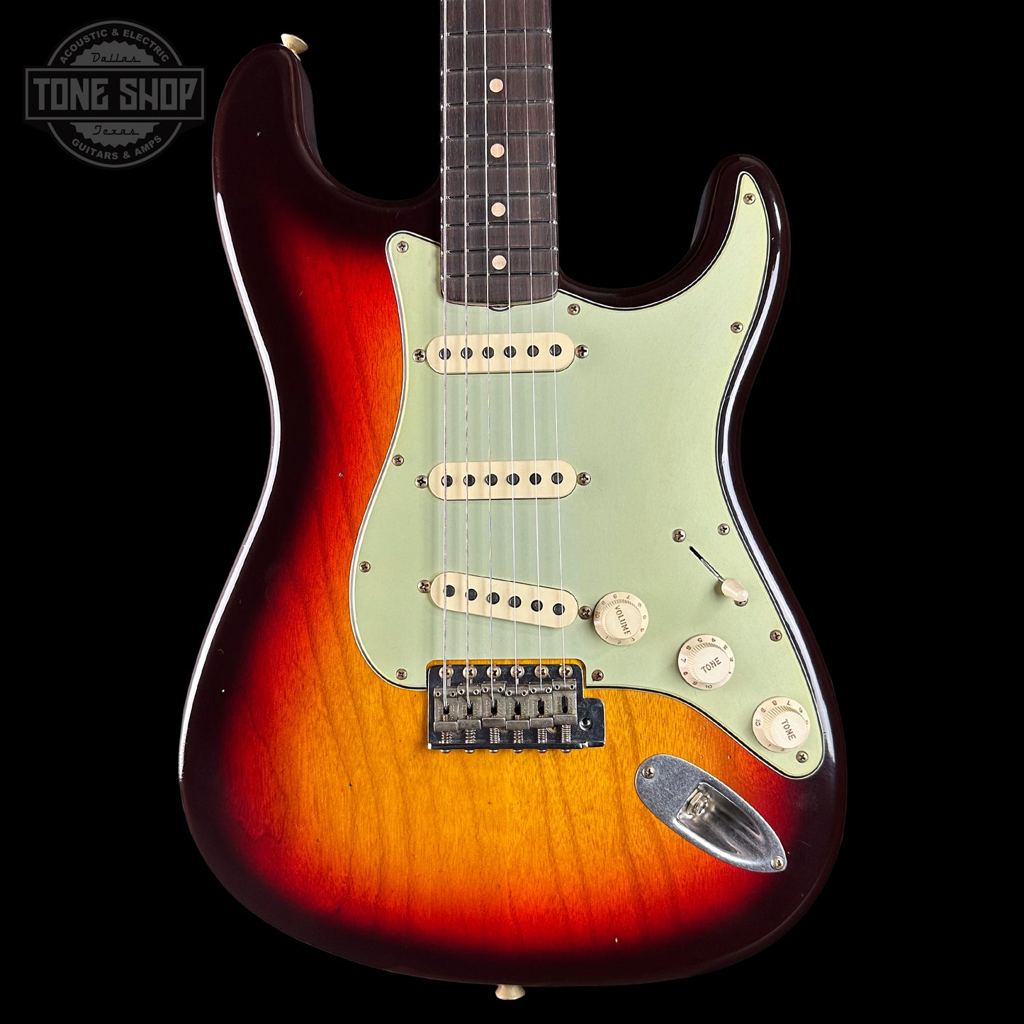 Electric guitar with a sunburst finish on a black background, featuring the Tone Shop logo.