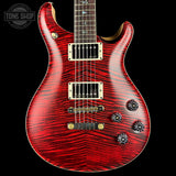 Red electric guitar with a black background