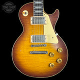 Electric guitar with a sunburst finish on a black background, featuring the Tone Shop logo.