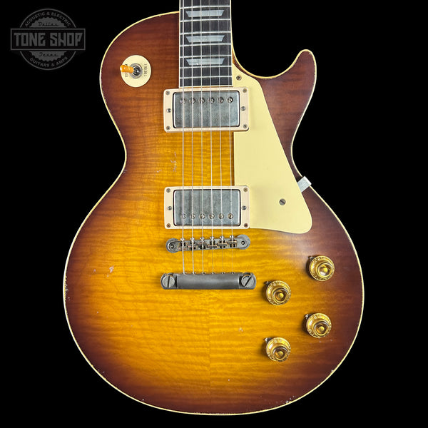 Electric guitar with a sunburst finish on a black background, featuring the Tone Shop logo.