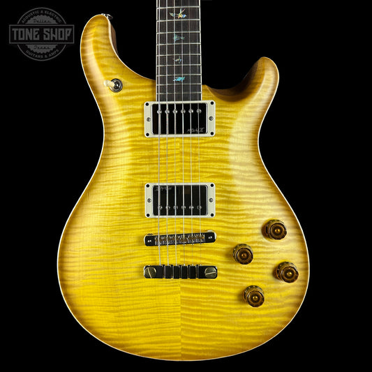 Yellow electric guitar with a black background