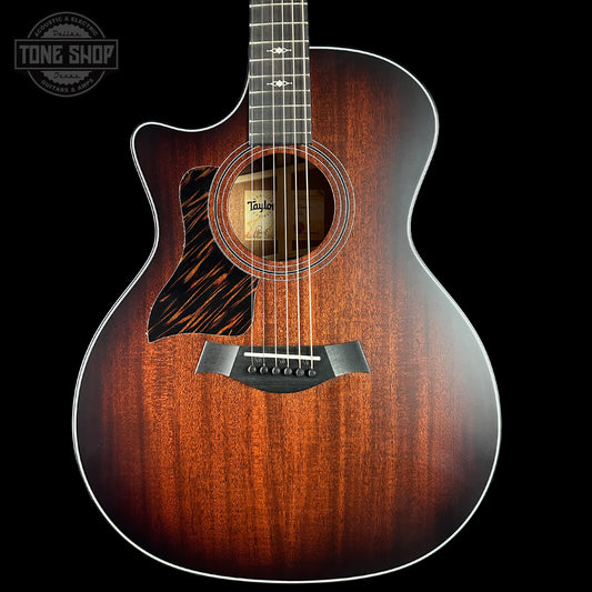 Taylor acoustic guitar with a sunburst finish on a black background, featuring the Tone Shop logo.