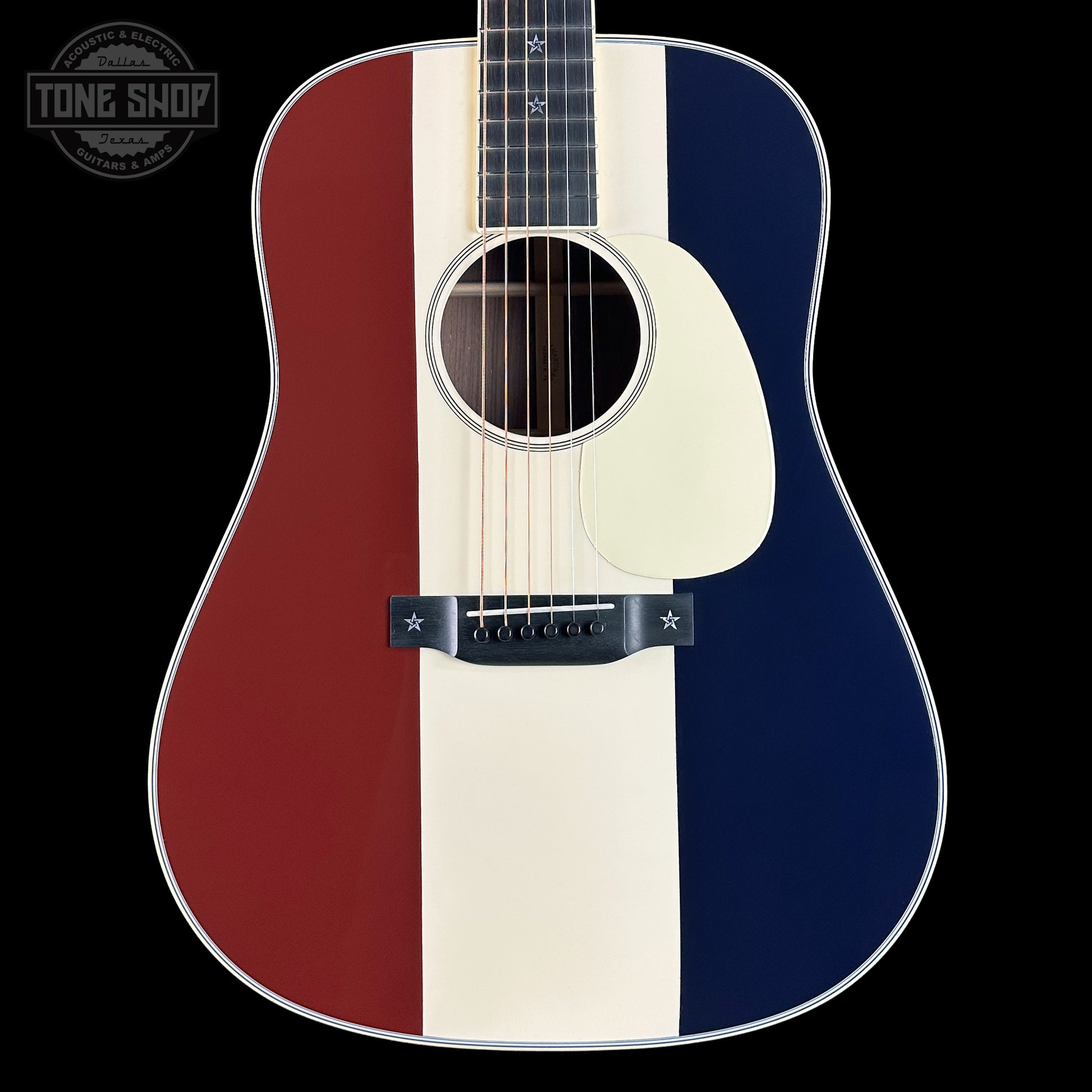 Acoustic guitar with a red, white, and blue striped design on a black background.