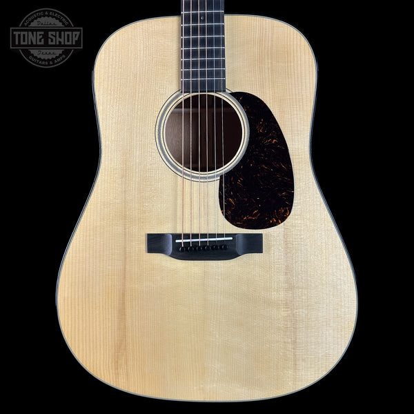 Acoustic guitar with a visible brand logo in the corner