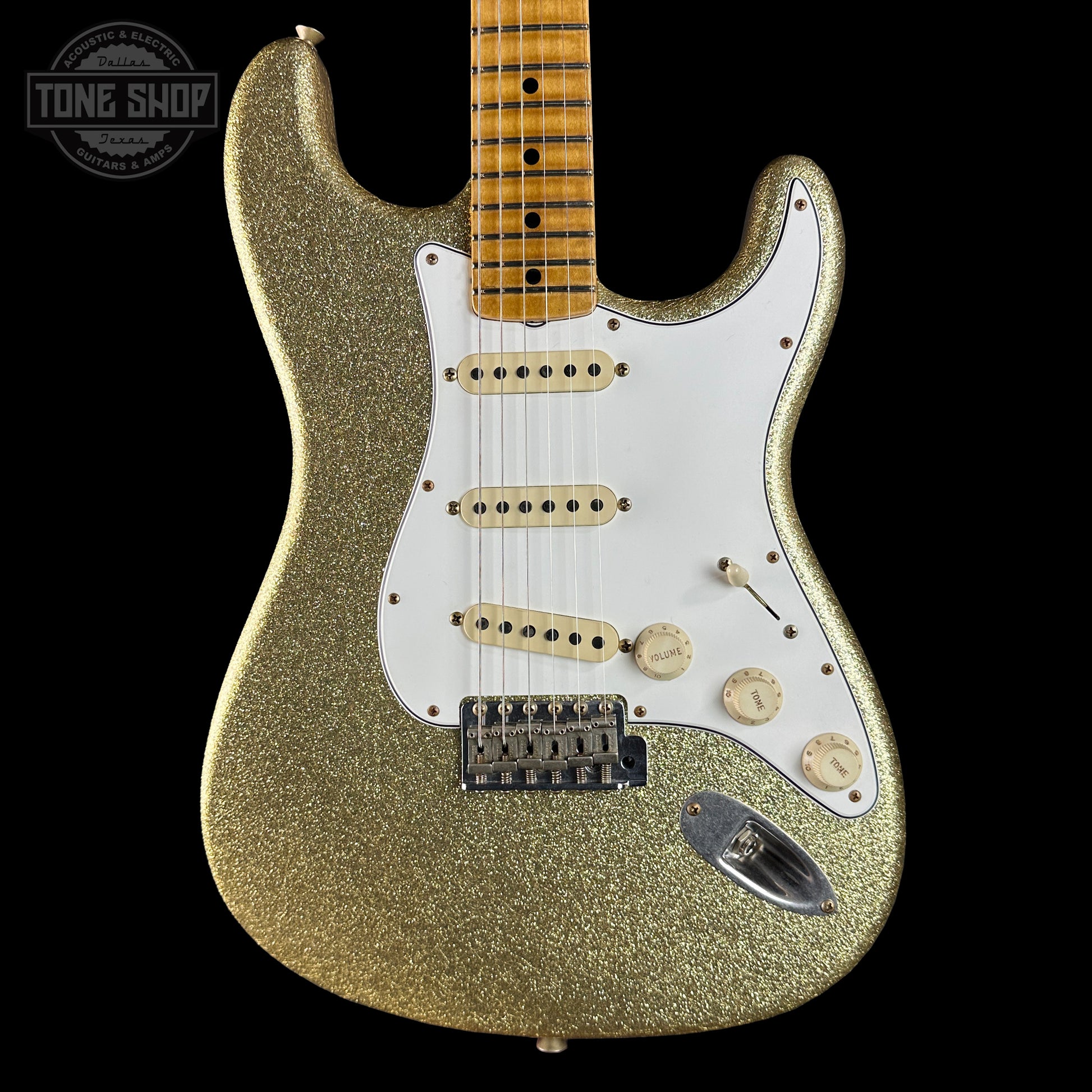Gold glitter electric guitar on a black background with 'Tone Shop' logo.