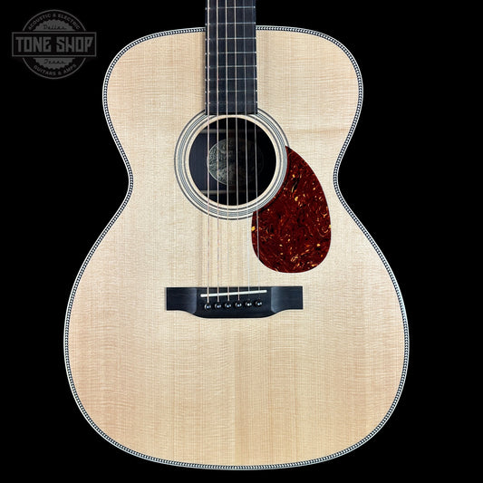 Acoustic guitar with a visible brand logo on a black background