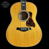 Acoustic guitar with a visible brand logo in the corner