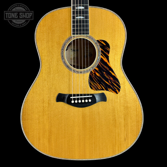 Acoustic guitar with a visible brand logo in the corner