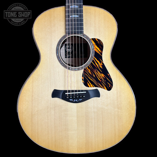 Acoustic guitar with a tiger stripe pattern on a black background, featuring the Tone Shop logo.