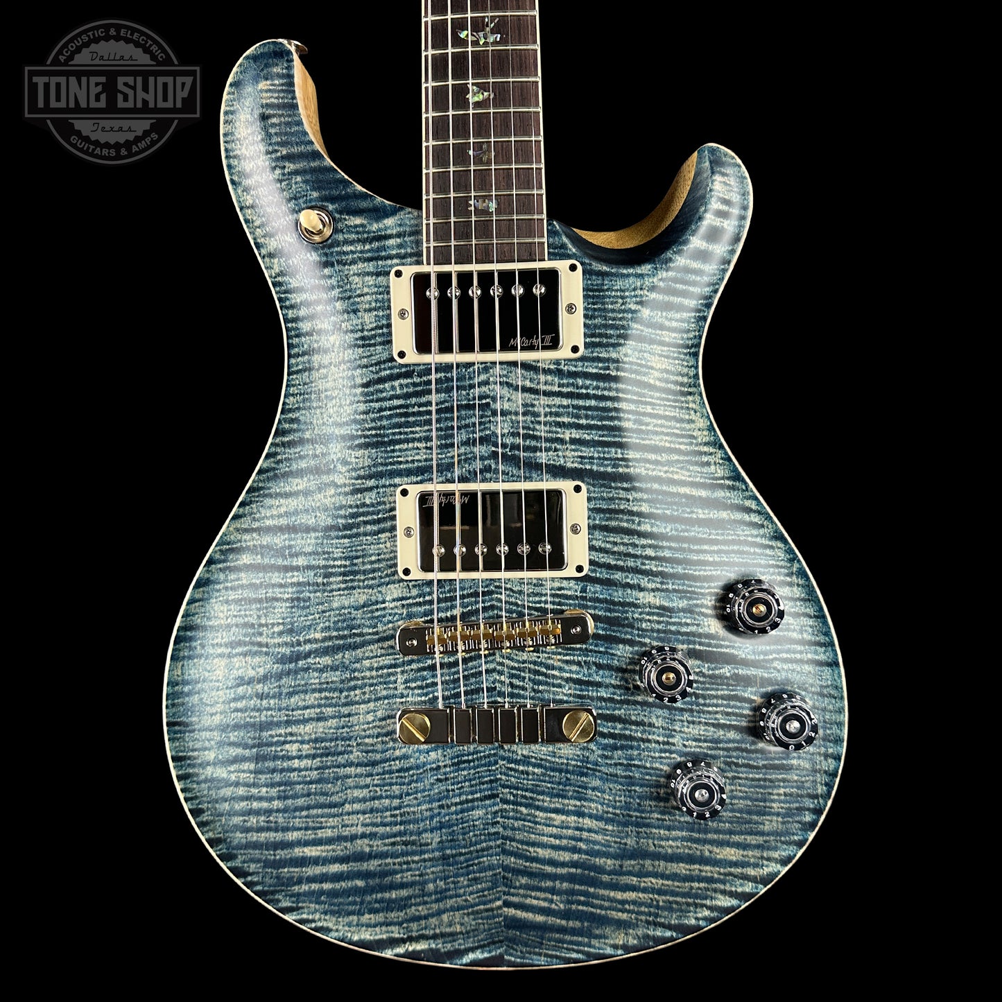 Blue electric guitar with a black background