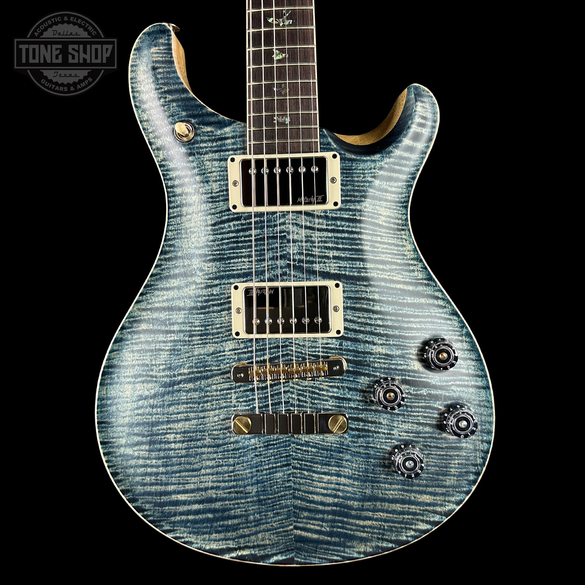 Blue electric guitar with a black background