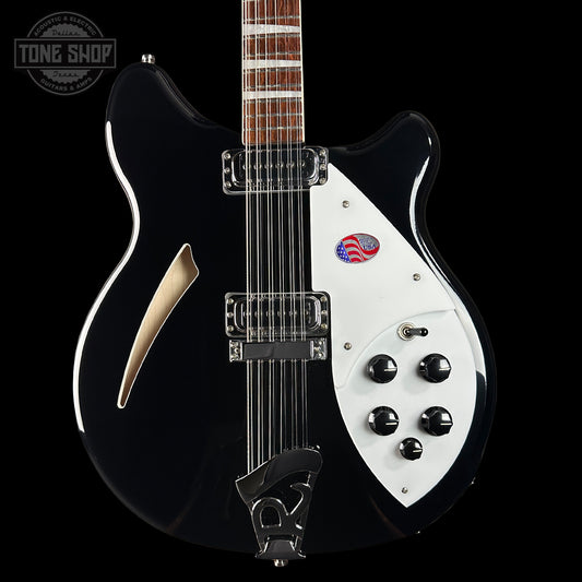 Black and white electric guitar with visible branding on a black background