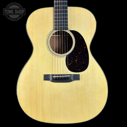 Acoustic guitar with a visible brand logo on a black background