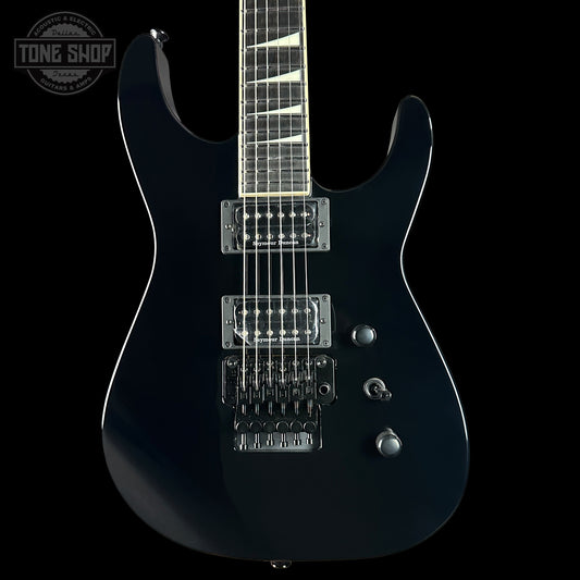 Black electric guitar on a black background with 'Tone Shop' logo.